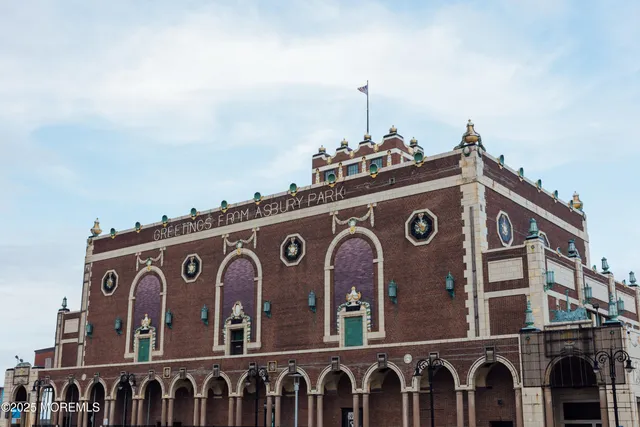 a front view of a building with glass top and deck