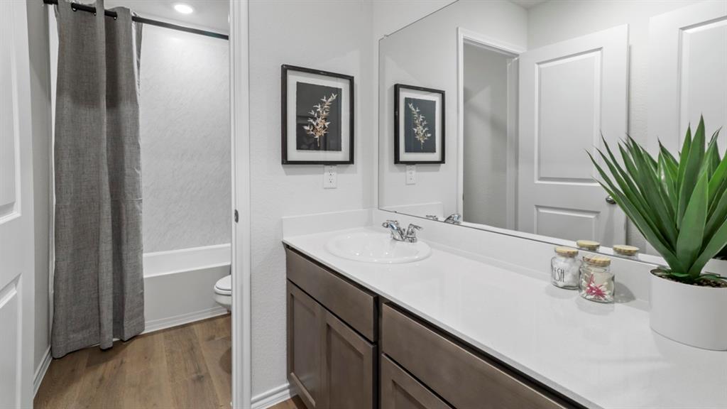 636 Dunham Road Nevada, TX 75173 - Photo 2 of 31 Bathroom vanity featuring an integrated sink, polished chrome faucet, and expansive countertop
