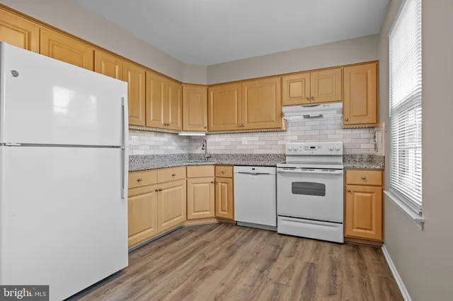 a kitchen with a white cabinets and white appliances