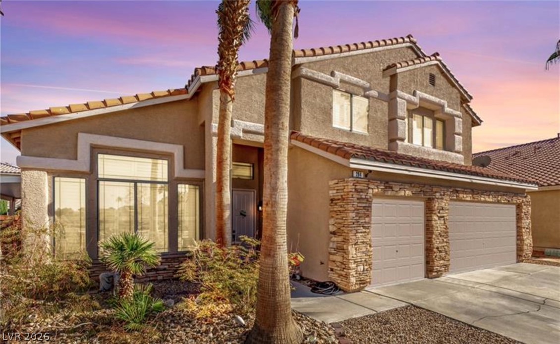 264 Pointe Ranier Avenue Henderson, NV 89012 - Photo 1 of 43 An inviting exterior with desert landscaping and a stone-accented garage enhances this captivating residence.