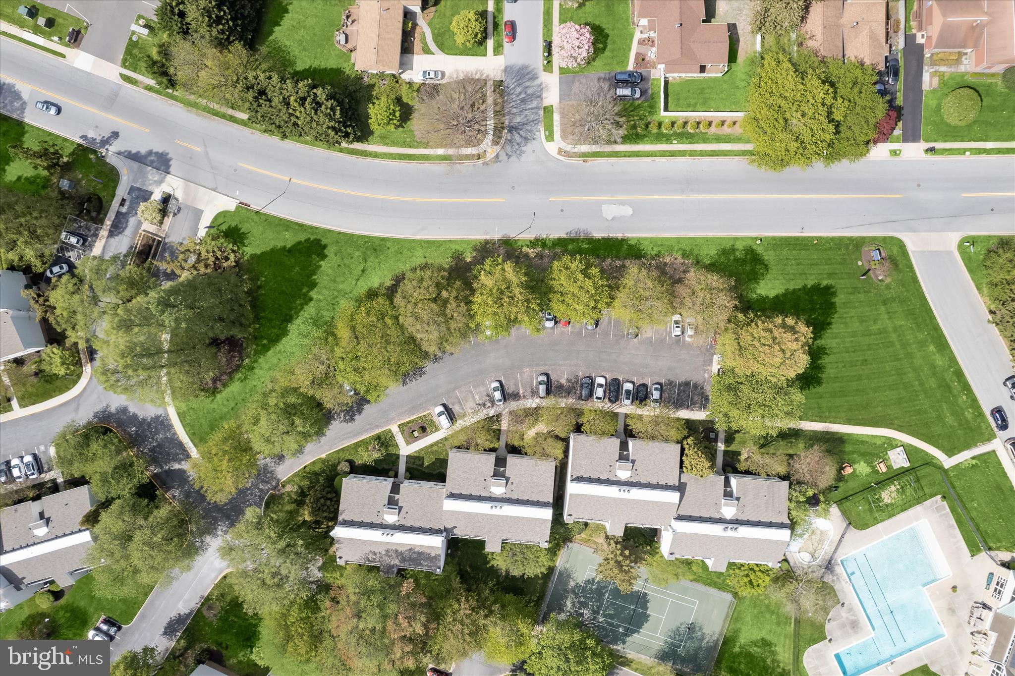 an aerial view of a house with a garden and swimming pool