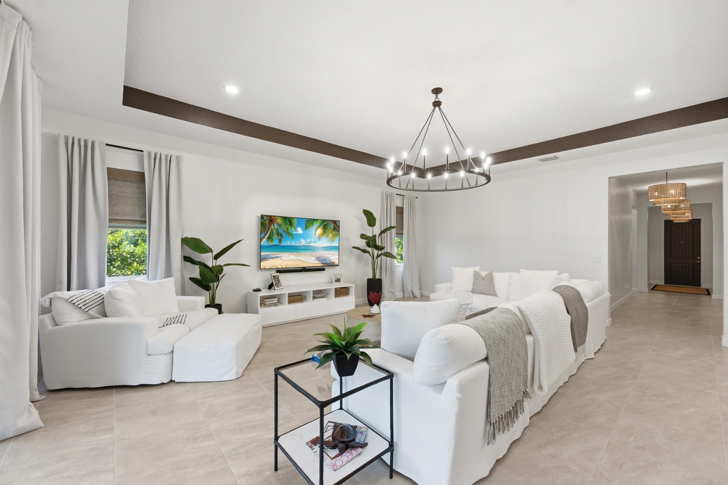 19230 Rolling Acres Road Loxahatchee, FL 33470 - Photo 11 of 58 a living room with furniture chandelier and a chandelier