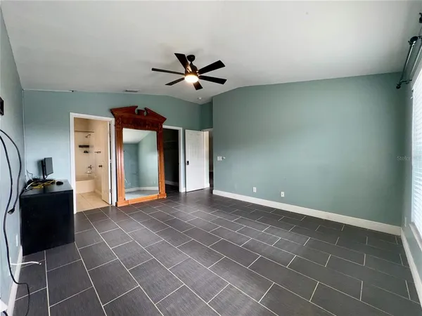 a view of a livingroom with a ceiling fan and window