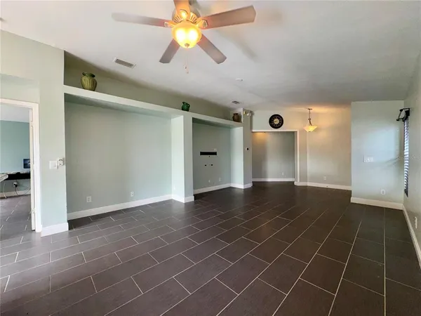 an empty room with a space and windows