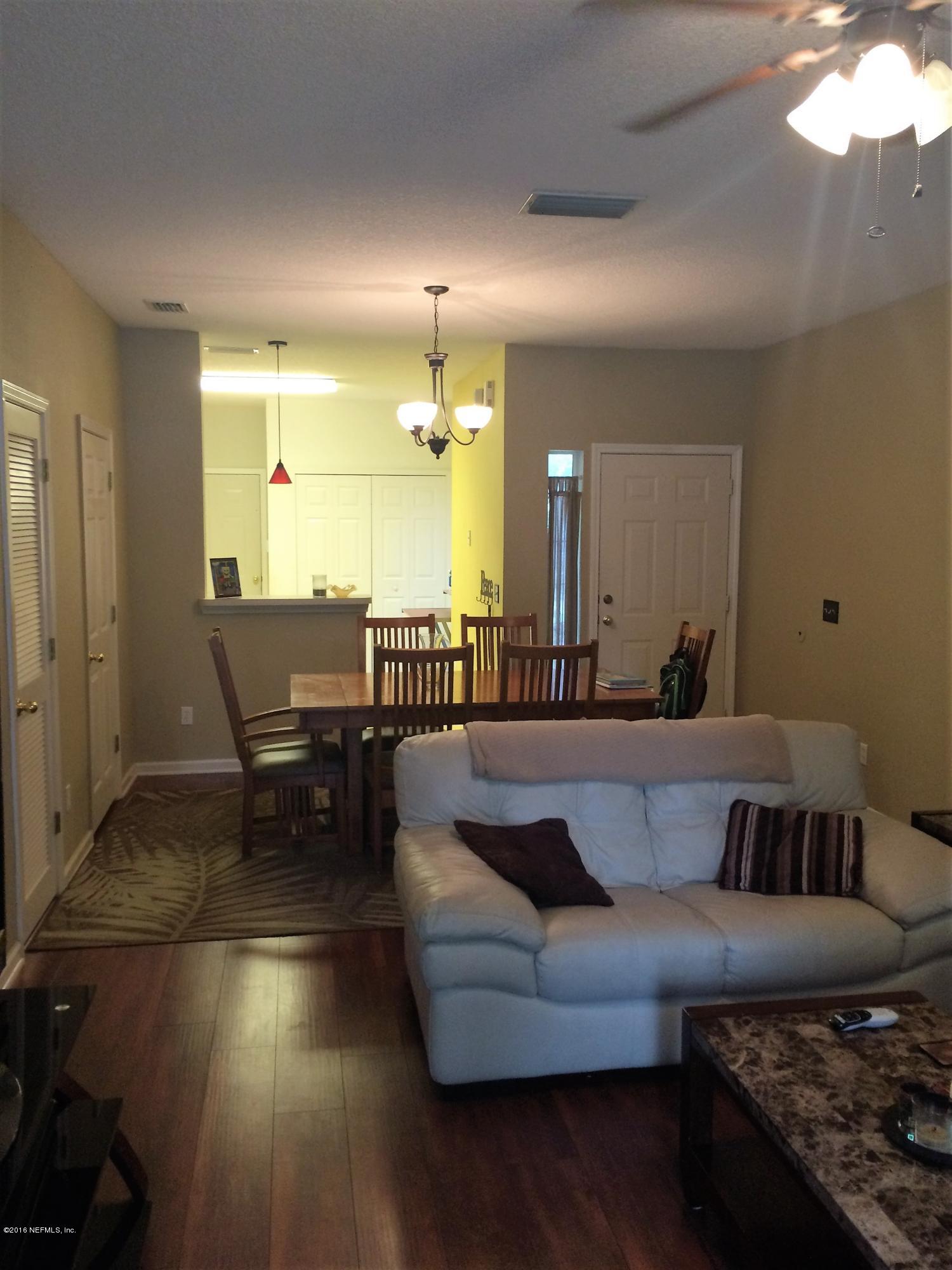 339 Southern Branch Lane St. Johns, FL 32259 - Photo 1 of 2 a living room with furniture and a dining table with wooden floor