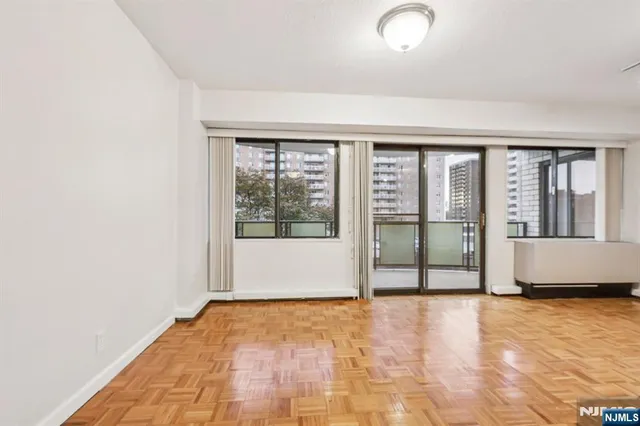 a view of an empty room with a fireplace