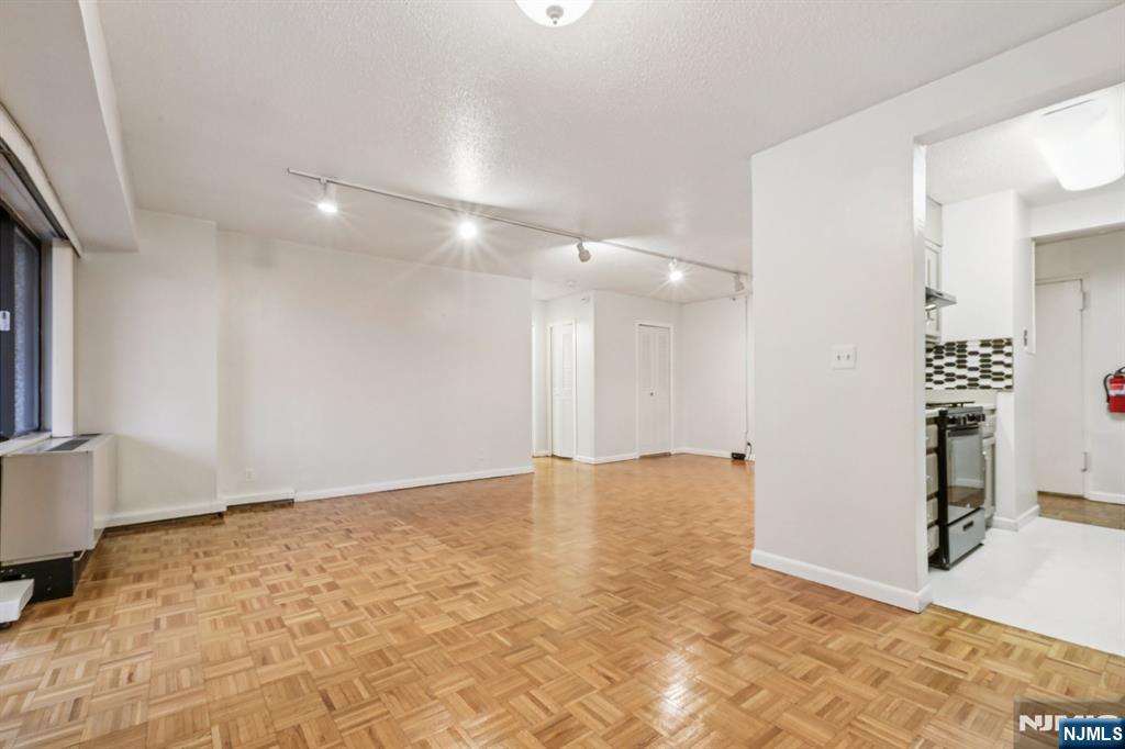 150 Overlook Avenue, Unit 6H Hackensack, NJ 07601 - Photo 16 of 29 a view of an empty room with a fireplace