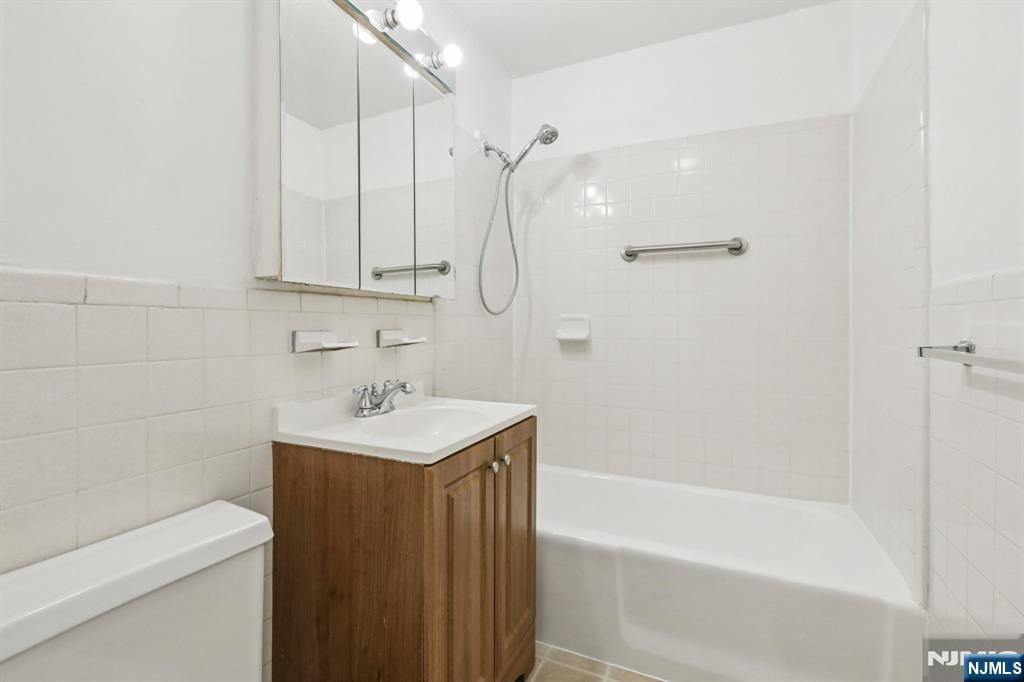 150 Overlook Avenue, Unit 6H Hackensack, NJ 07601 - Photo 20 of 29 a bathroom with a sink a toilet and shower