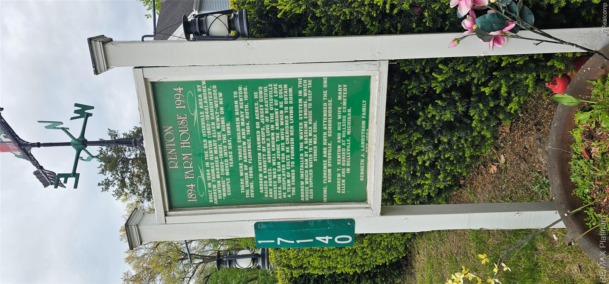 17140 Haggerty Road Belleville, MI 48111 - Photo 4 of 42 White signpost featuring a green historical marker, topped with a black and green weathervane