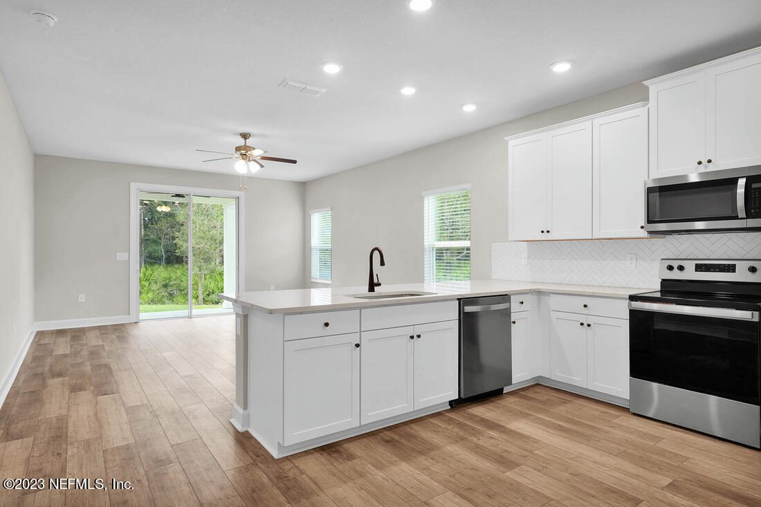 748 Morgans Treasure Road St. Augustine, FL 32084 - Photo 4 of 10 a kitchen with a sink window and stainless steel appliances