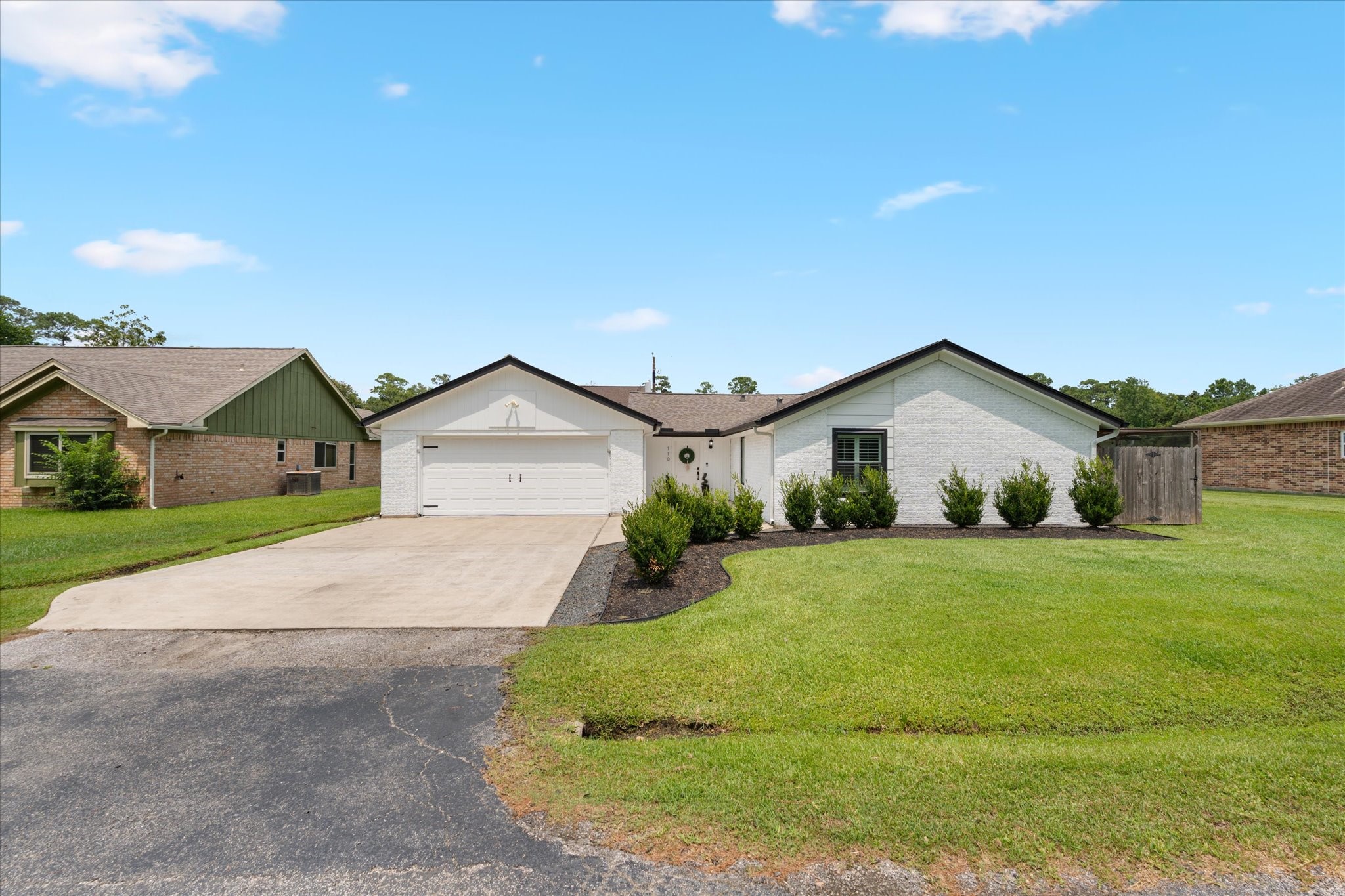 110 Dozent Lane Baytown, TX 77521 - Photo 1 of 36 This is a single-story home with a white exterior and a two-car garage. It features a well-maintained front yard with shrubs and a spacious driveway.