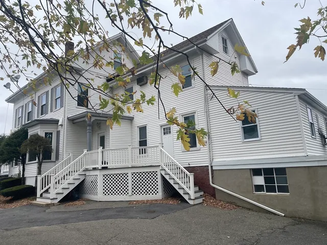 a view of a house with a snow in the road