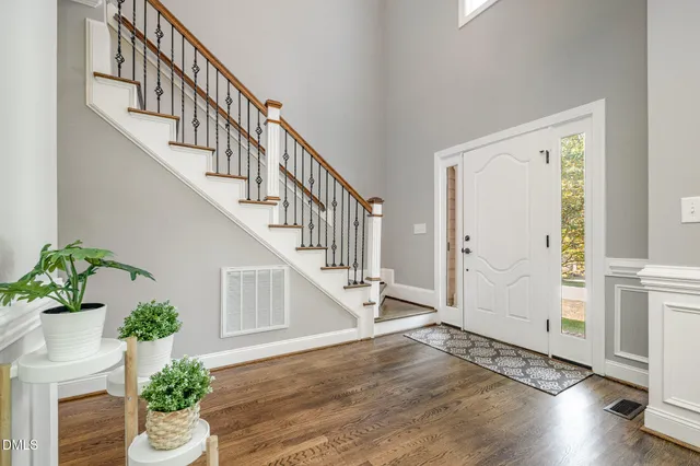 a view of entryway and hall with wooden floor