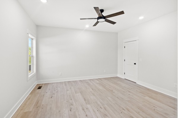 1030 Hanestown Road Lafayette, TN 37083 - Photo 26 of 48 an empty room with wooden floor ceiling fan and window