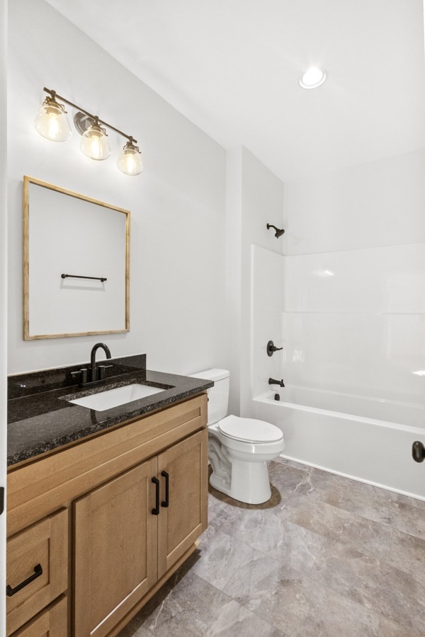 1030 Hanestown Road Lafayette, TN 37083 - Photo 33 of 48 a bathroom with a granite countertop sink mirror vanity and toilet