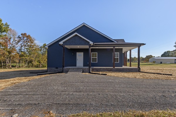 1030 Hanestown Road Lafayette, TN 37083 - Photo 4 of 48 a front view of a house with a yard
