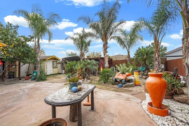 a view of a backyard with plants and swimming pool