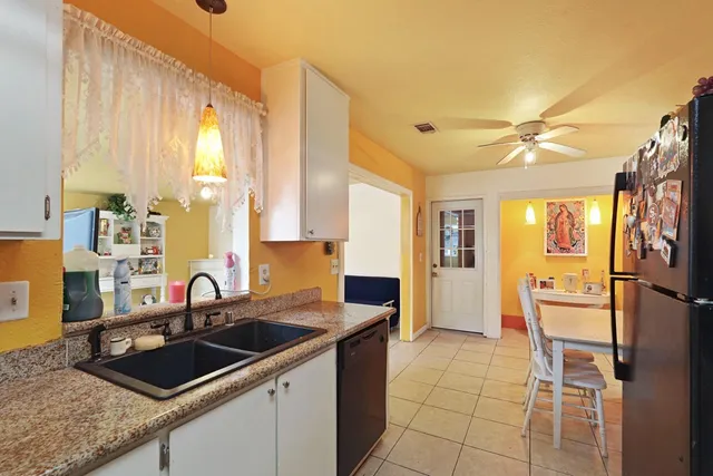 a kitchen with a sink appliances and cabinets