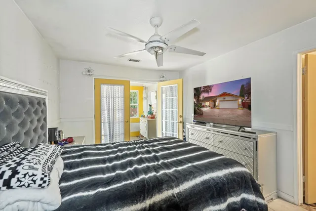 a bedroom with a bed and a flat screen tv