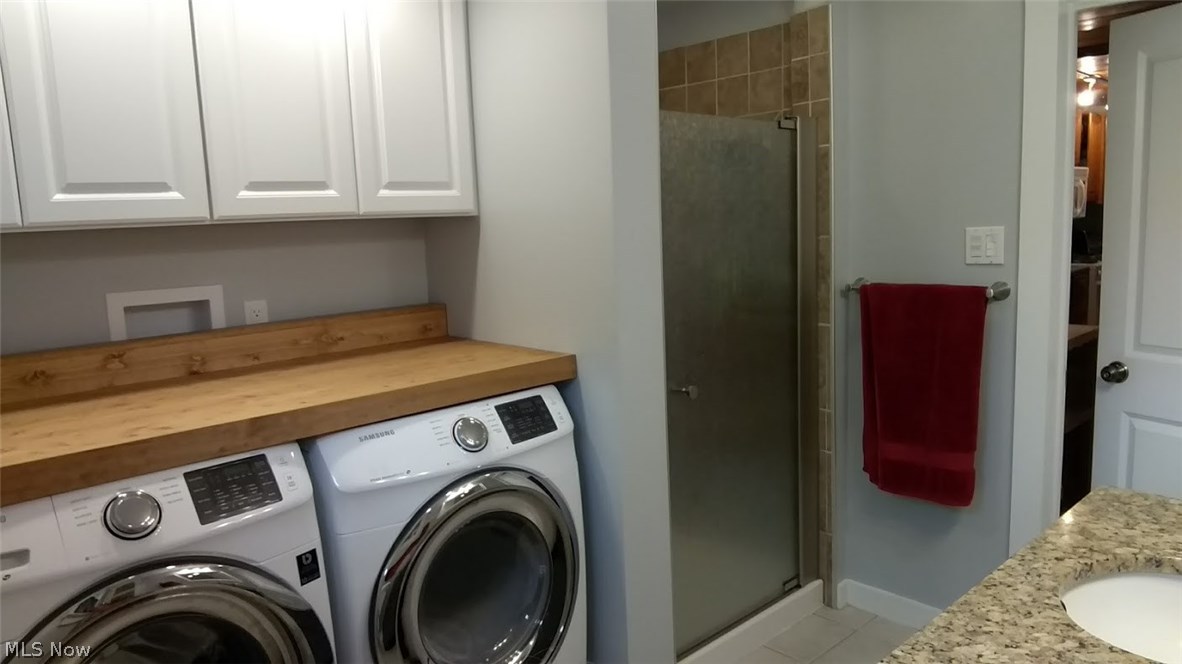 208 Prospect Road Berea, OH 44017 - Photo 11 of 20 Another floor of first floor bath/laundry. Notice the convenient folding area over the washer and dryer, which are included!