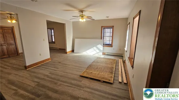 a view of livingroom with hardwood floor and a ceiling fan