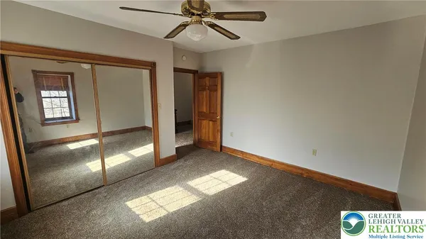 an empty room with windows and closet