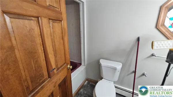a white toilet sitting next to a small yard