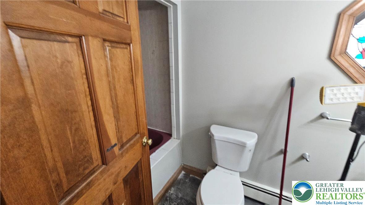 253 West Main Street Bath, PA 18014 - Photo 19 of 30 a white toilet sitting next to a small yard