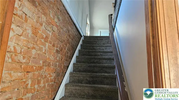 a view of staircase with white walls and windows