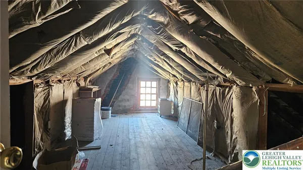a view of walk in closet with wooden floor