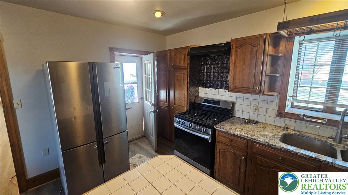 253 West Main Street Bath, PA 18014 - Photo 5 of 30 a kitchen with stainless steel appliances granite countertop a refrigerator stove and sink