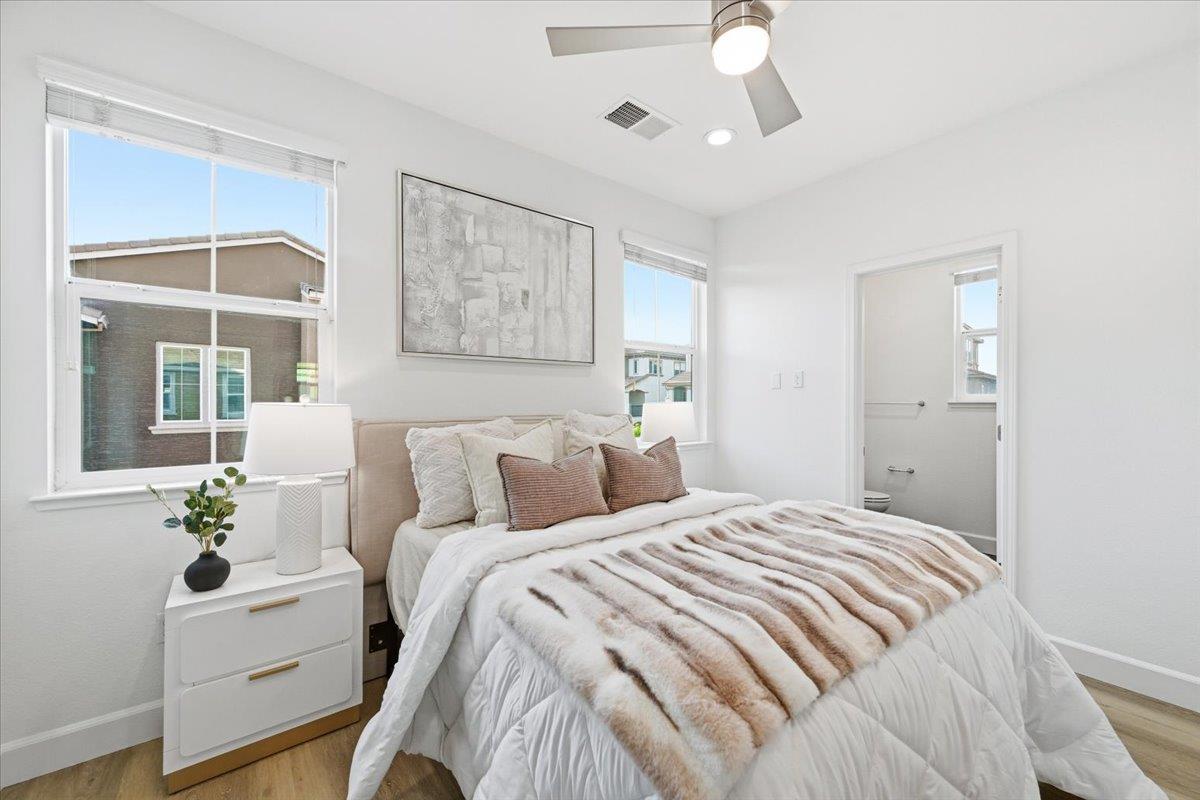 5614 Oceanspray Road Newark, CA 94560 - Photo 20 of 52 a bedroom with a bed and a chandelier
