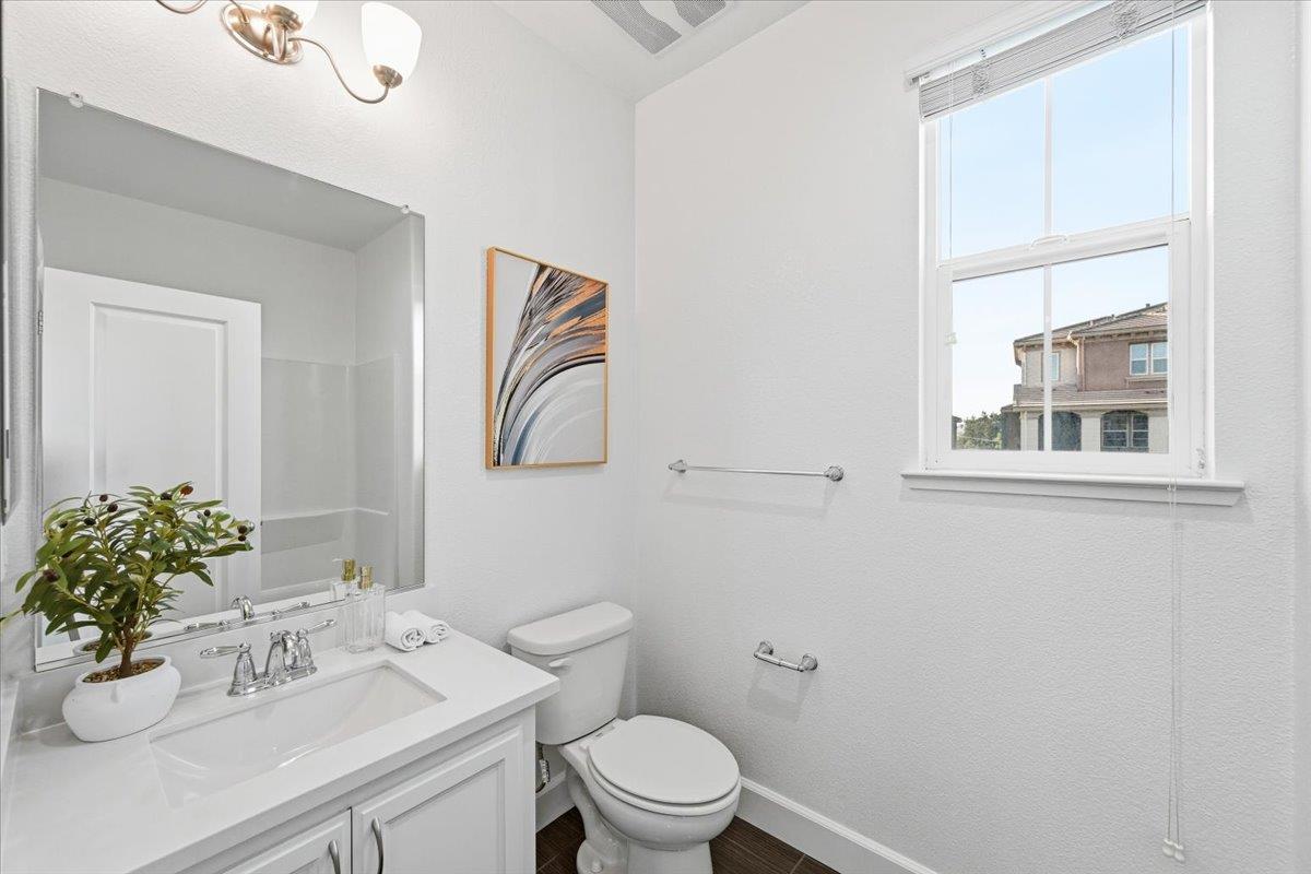 5614 Oceanspray Road Newark, CA 94560 - Photo 23 of 52 a bathroom with a sink mirror and toilet