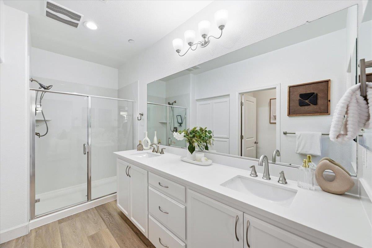 5614 Oceanspray Road Newark, CA 94560 - Photo 30 of 52 a bathroom with a double vanity sink mirror and shower