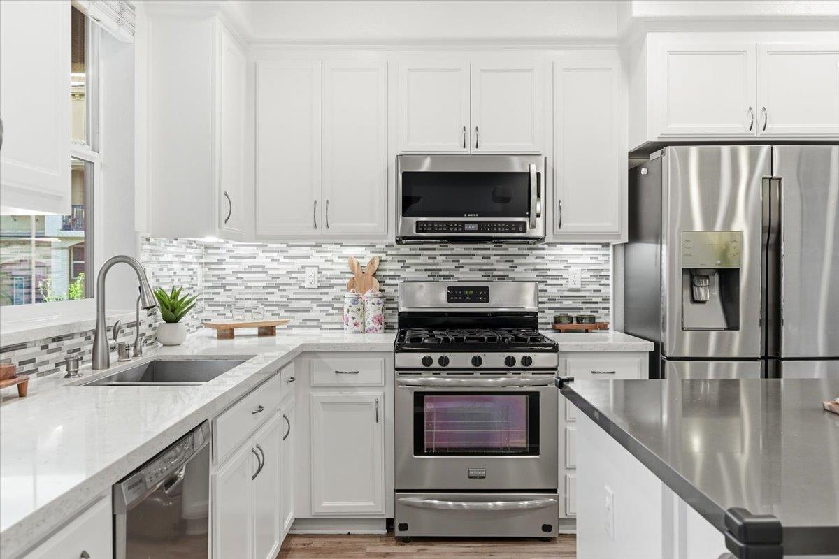5614 Oceanspray Road Newark, CA 94560 - Photo 10 of 52 a kitchen with cabinets stainless steel appliances a sink and a counter space