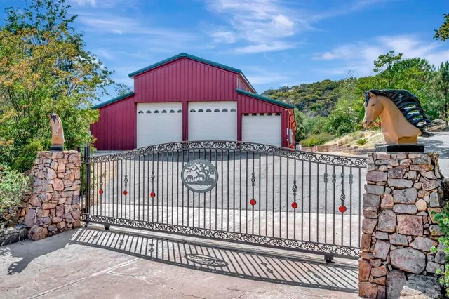 a front view of a house with a wrought fence