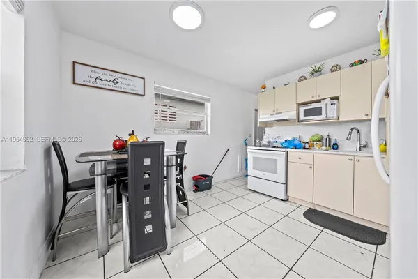 a kitchen with stainless steel appliances a refrigerator sink and cabinets
