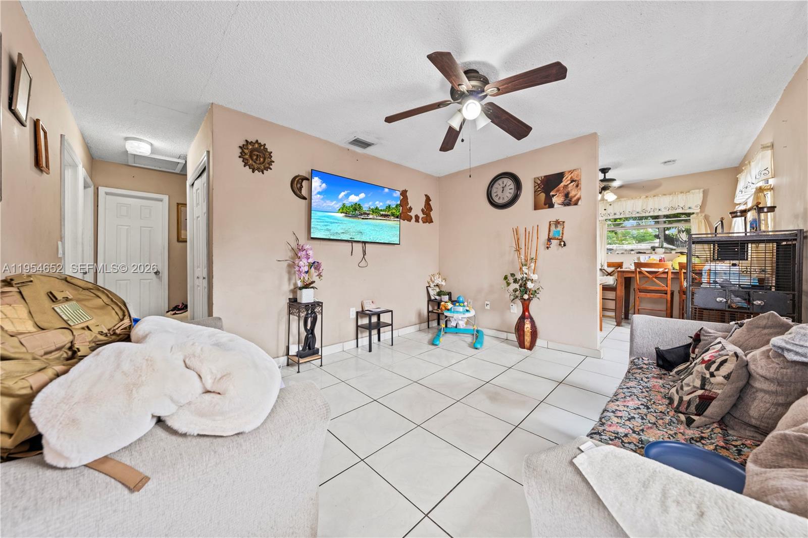 2110 Northwest 34th Street Miami, FL 33142 - Photo 18 of 33 a living room with furniture and a flat screen tv