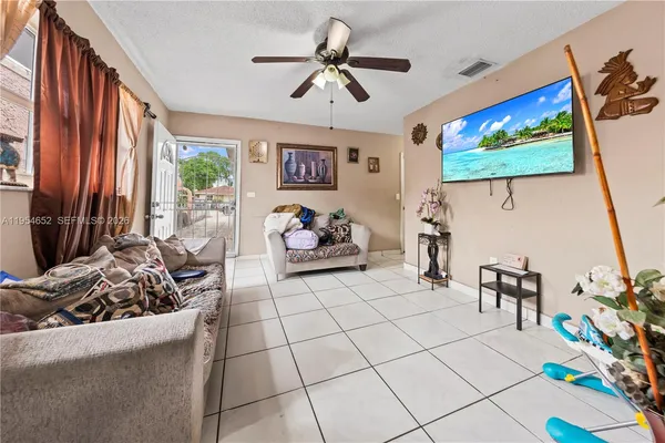 a kitchen with stainless steel appliances kitchen island granite countertop a refrigerator and a sink