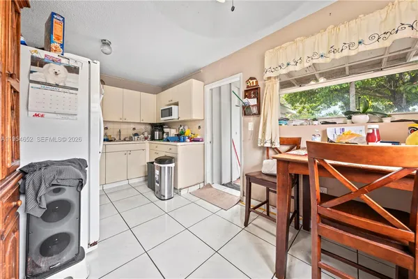 a kitchen with refrigerator and cabinets