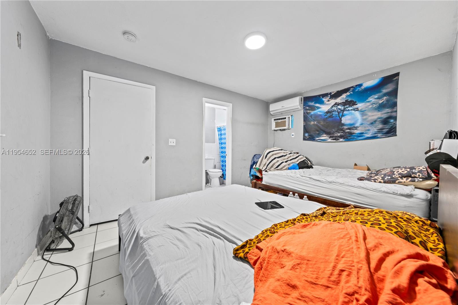 2110 Northwest 34th Street Miami, FL 33142 - Photo 23 of 33 a bedroom with a bed and a chandelier