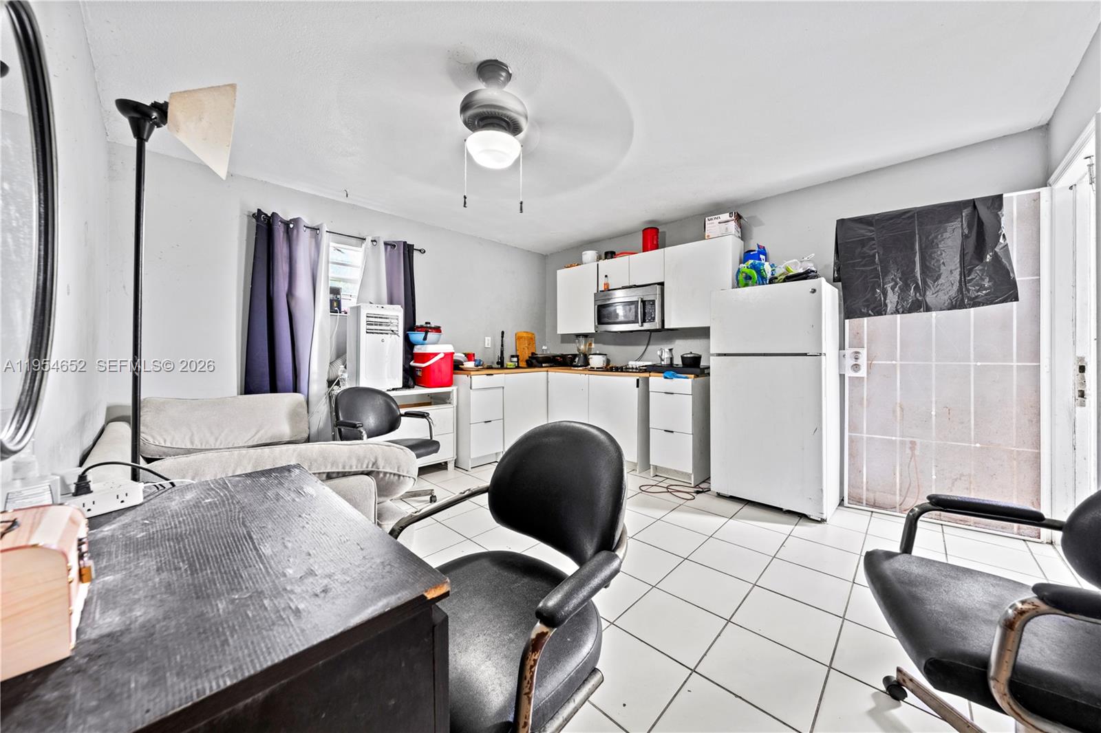 2110 Northwest 34th Street Miami, FL 33142 - Photo 25 of 33 a kitchen with a sink appliances and cabinets