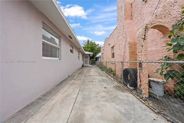 a view of a house with backyard and sitting area