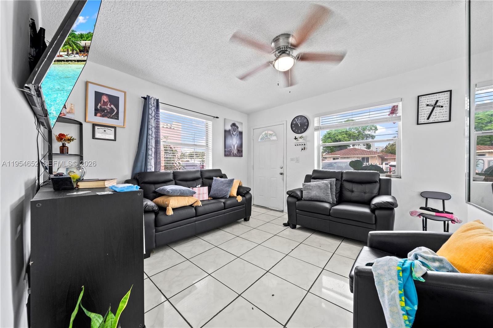 2110 Northwest 34th Street Miami, FL 33142 - Photo 9 of 33 a living room with furniture and a flat screen tv