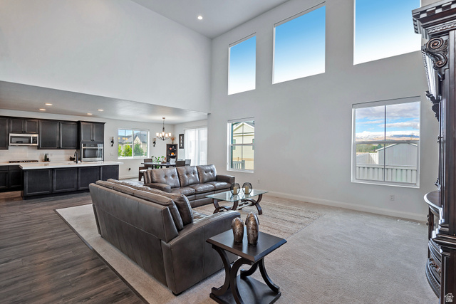 11694 Engelmann Drive Draper, UT 84020 - Photo 10 of 41 Living room featuring a chandelier and a high ceiling