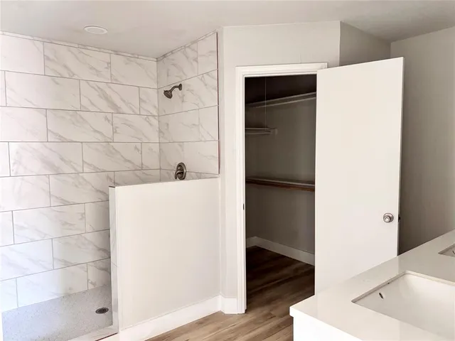 a bathroom with a bathtub and a shower