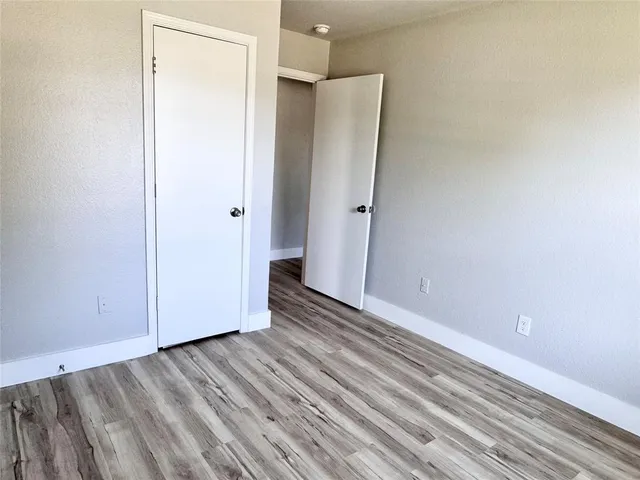 a view of a room with wooden floor