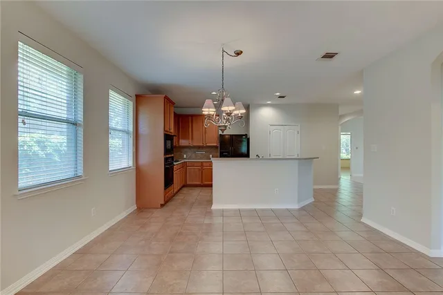 a view of a kitchen with a sink and a chandelier