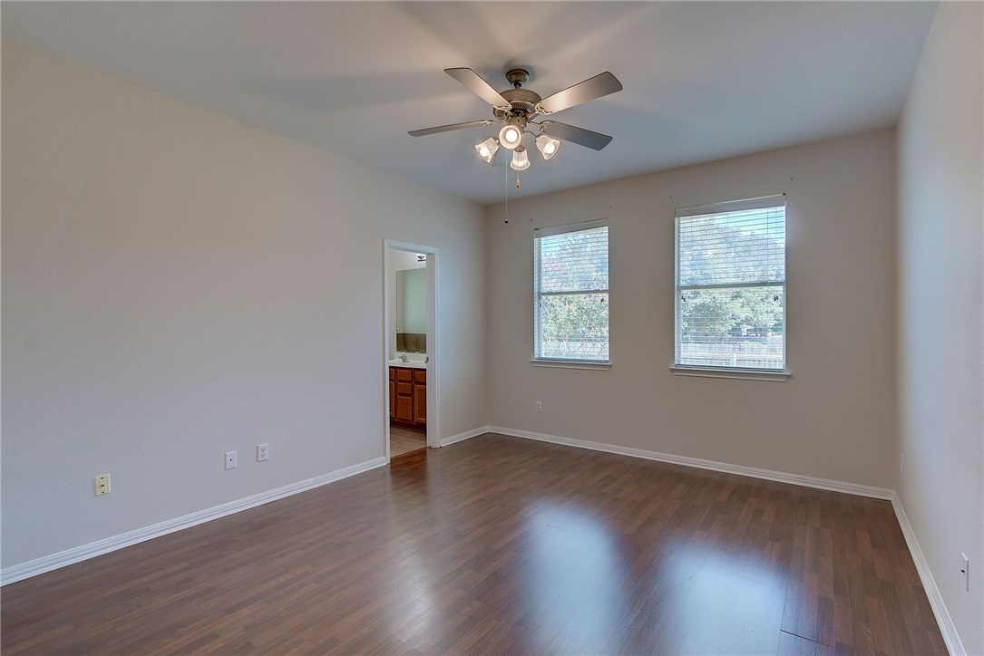 2993 Freemont Street Round Rock, TX 78681 - Photo 15 of 32 a view of an empty room with wooden floor and a window