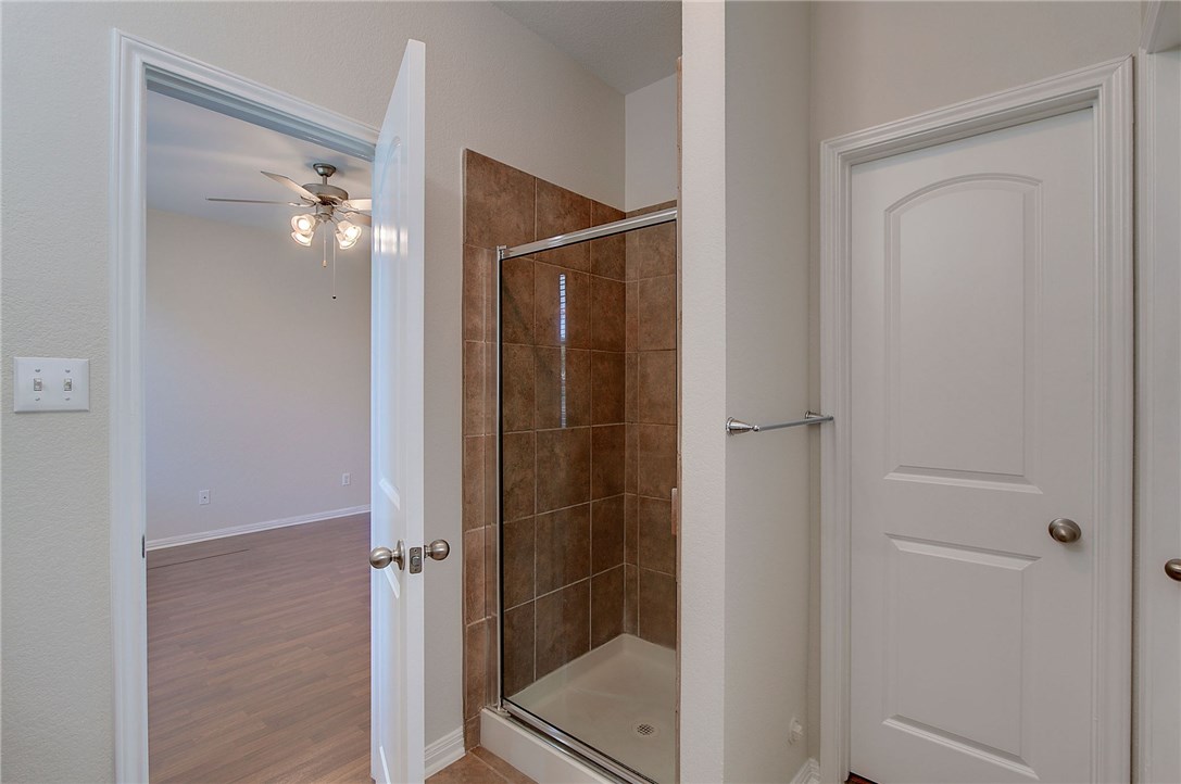 2993 Freemont Street Round Rock, TX 78681 - Photo 19 of 32 a bathroom with a shower and a glass door